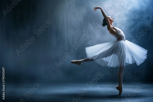 Ballerina in a white tutu gracefully dances in darkness