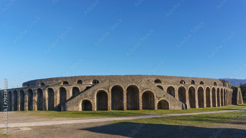 Ruins of Amphitheatre on a sunny day in ancient city of Pompeii, Campania, Italy