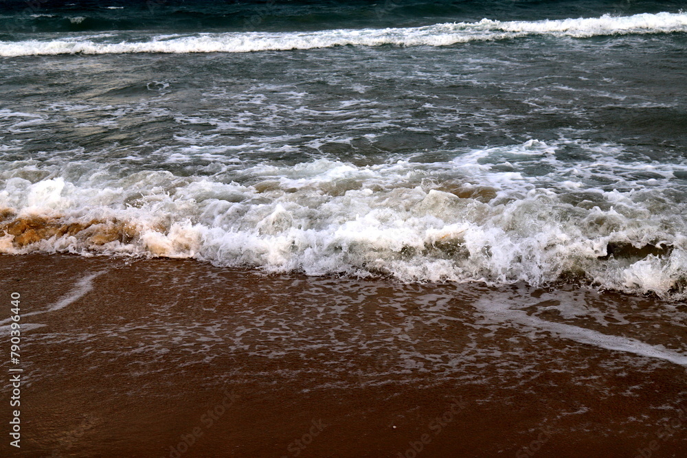 Beautiful sea waves on seashore at dawn, sea water foam. Sunrise, Sunset, Backlight Beautiful sea waves on seashore at dawn, sea water foam. Sunrise, Sunset, Backlight