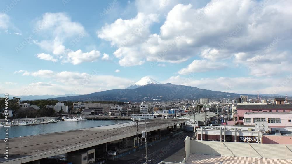 SHIZUOKA, JAPAN - MARCH 2024 : View around Numazu Port in daytime. Tucked in between Mount Fuji to the north and Suruga Bay to the south. Famous for fresh seafood and fish market. Time lapse shot. SHIZUOKA, JAPAN - MARCH 2024 : View around Numazu Port in daytime. Tucked in between Mount Fuji to the north and Suruga Bay to the south. Famous for fresh seafood and fish market. Time lapse shot.