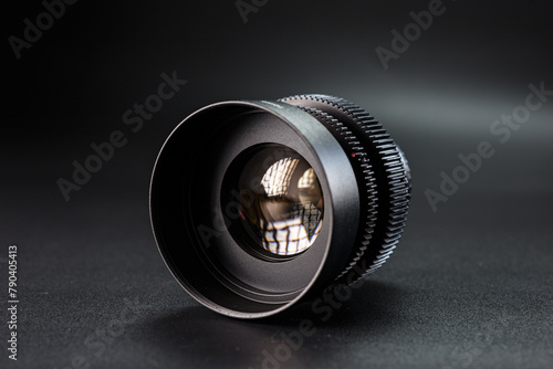 Professional black vintage camera lens, prominently displayed, Helios branding, intricate light reflections, essential tool for photographers, isolated on a dark backdrop.