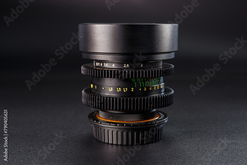 Detailed camera lens stack with visible aperture numbers, focus settings for photography experts, vintage design, precision tool on dark texture