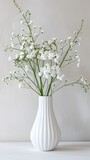 Vase Filled With White Flowers on desk in room , copy space for text