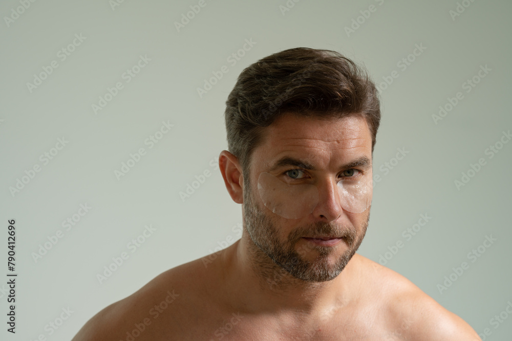 man with healthy skin. Head shot portrait smiling American young man with naked shoulders checking wrinkles or acne on forehead, looking at camera, facial cosmetology, treatment, skincare concept man with healthy skin. Head shot portrait smiling American young man with naked shoulders checking wrinkles or acne on forehead, looking at camera, facial cosmetology, treatment, skincare concept