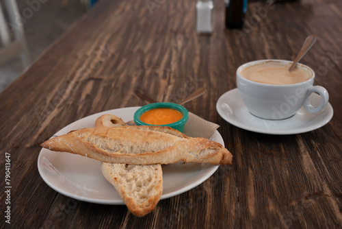 Delicious breakfast. Toast with Andalusian tomato sauce and freshly brewed coffee at the cafeteria table.