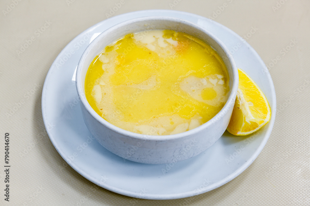 Homemade turkish soup Tavuk Suyu corbasi in a white ceramic soup plate.Turkish noodle chicken broth soup on a plate. Turkish meal (sehriyeli tavuk suyu corbasi) Homemade turkish soup Tavuk Suyu corbasi in a white ceramic soup plate.Turkish noodle chicken broth soup on a plate. Turkish meal (sehriyeli tavuk suyu corbasi)