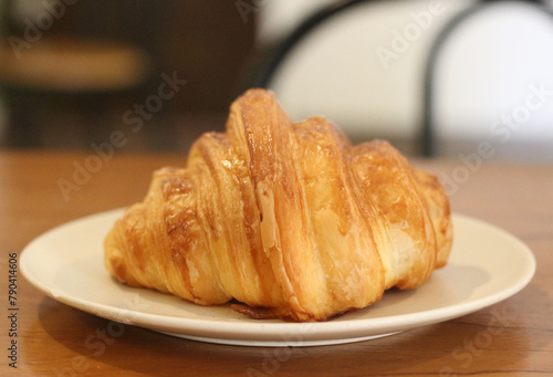 croissant on a plate on a table.