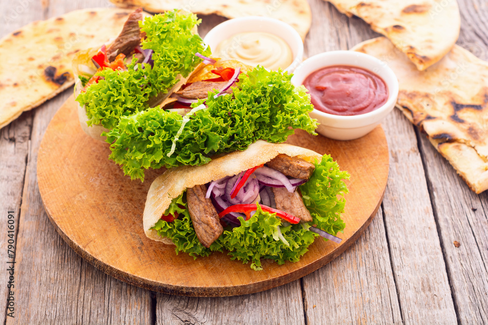 Pita with salad , paprika and beef meat . Traditional arabian and israel food Pita with salad , paprika and beef meat . Traditional arabian and israel food