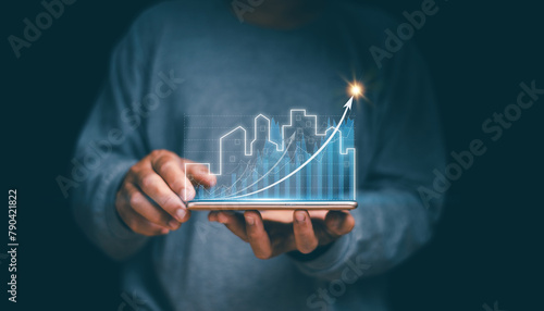 Concept of business prosperity and asset management, Real estate investment marketing analysis, Businessman holding mobile phone with graph of asset business growth, Planning to increase profits.