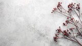 Red berries on slender branches against textured gray background