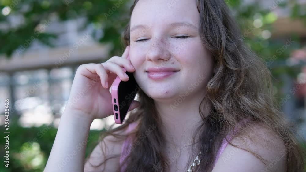 Young European business woman talking on the phone outside an office building. Cheerful girl dressed in formal clothes at a workplace. Person using a mobile to communicate with friends. Young European business woman talking on the phone outside an office building. Cheerful girl dressed in formal clothes at a workplace. Person using a mobile to communicate with friends.