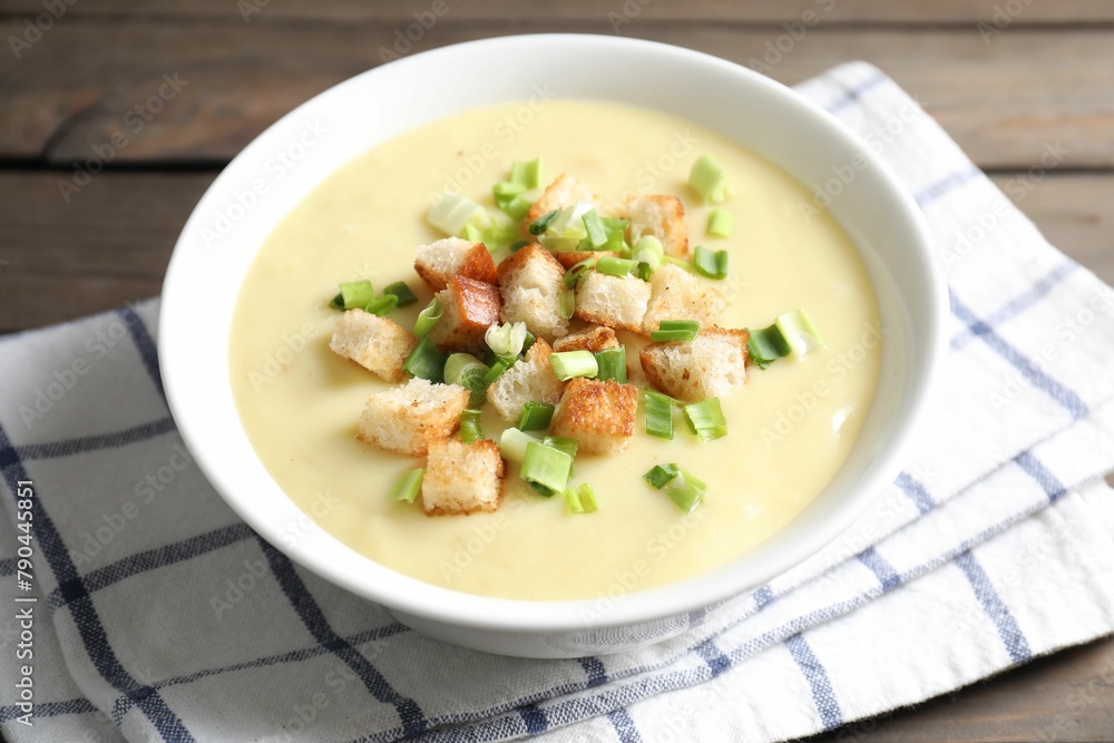 Tasty potato soup with croutons and green onion in bowl on table, closeup Tasty potato soup with croutons and green onion in bowl on table, closeup