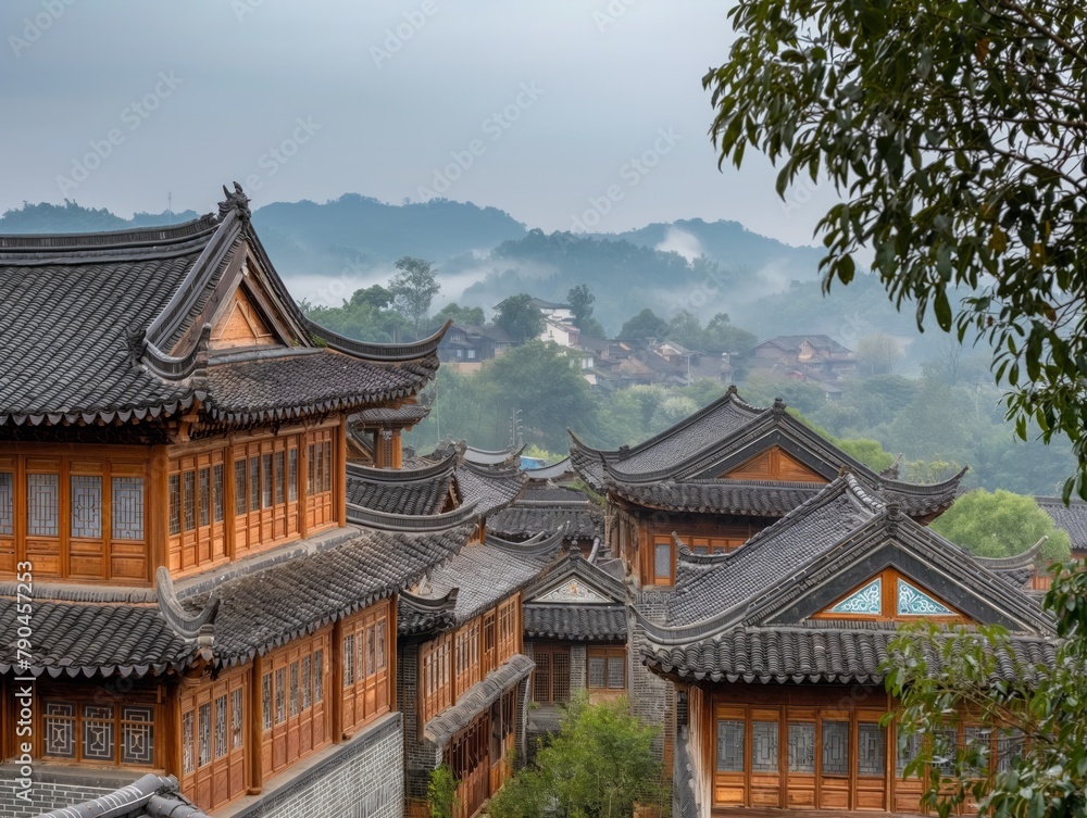 A row of houses with a view of the mountains. The houses are made of wood and have a traditional style. The sky is cloudy and the houses are surrounded by trees