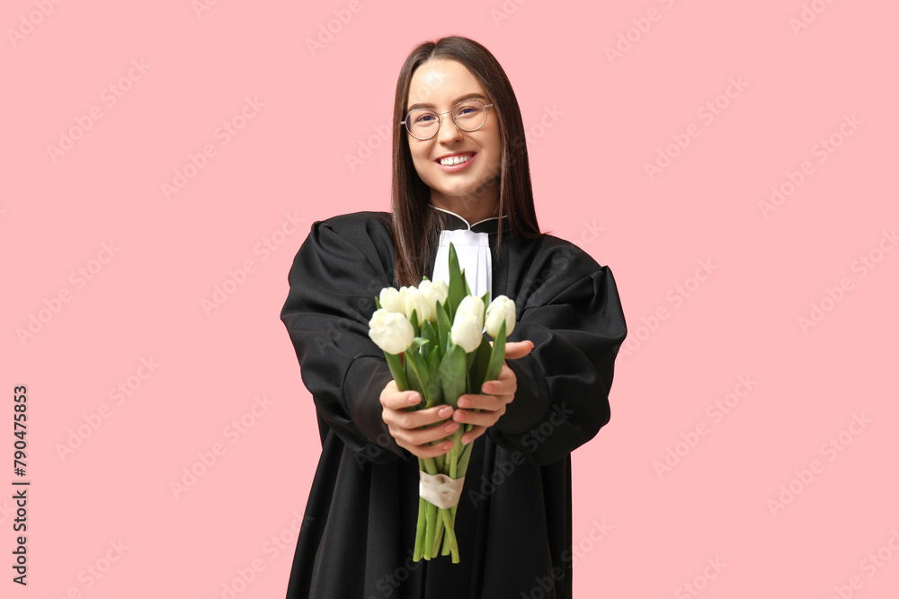 Young female judge with white tulips on pink background. Women's Day celebration Young female judge with white tulips on pink background. Women's Day celebration