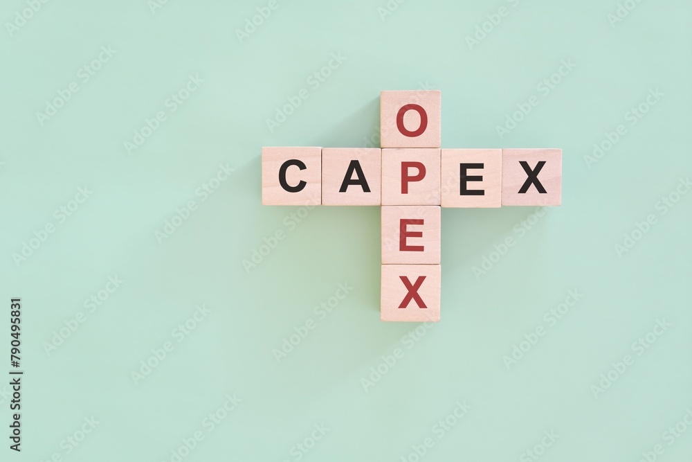 CAPEX versus OPEX concept. Crossword puzzle flat lay composition.