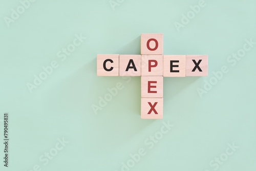 Obraz na płótnie CAPEX versus OPEX concept. Crossword puzzle flat lay composition. w salonie