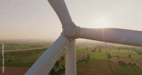 erial view of wind turbine farm with sunlight creating renewable energy photo