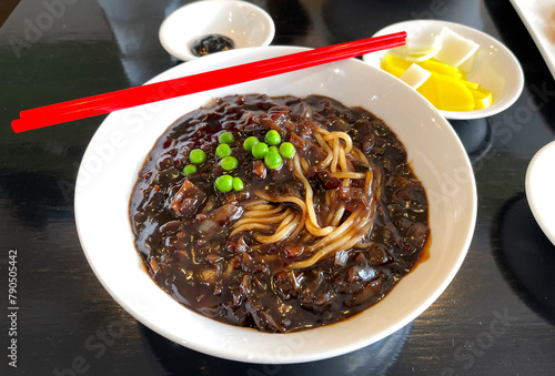 A bowl of Jajangmyeon, a popular Korean dish or noodles in a thick black bean sauce.
