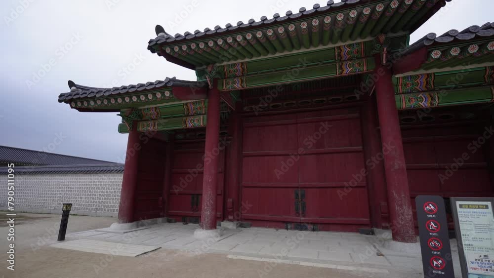 a traditional Korean building at Gyeongbokgung, Seoul, featuring intricate designs, vibrant colors, under a cloudy sky with a mountain in the background a traditional Korean building at Gyeongbokgung, Seoul, featuring intricate designs, vibrant colors, under a cloudy sky with a mountain in the background