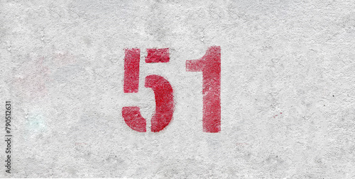 Red Number 51 on the white wall. Spray paint.
