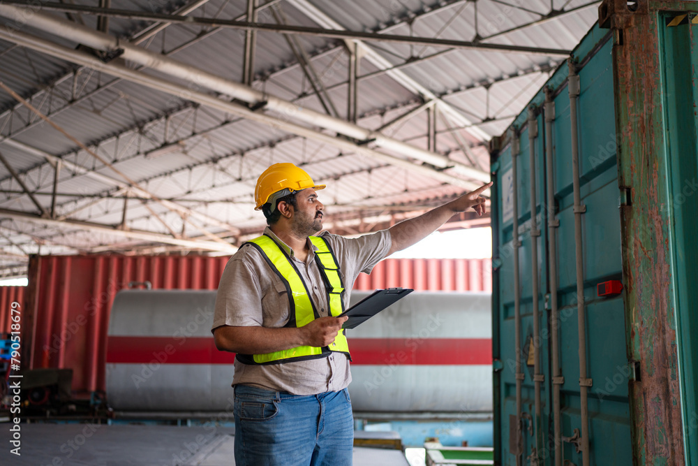 Portrait of male staff with holding clipboard working in warehouse, Industrial and industrial workers concept. Portrait of male staff with holding clipboard working in warehouse, Industrial and industrial workers concept.
