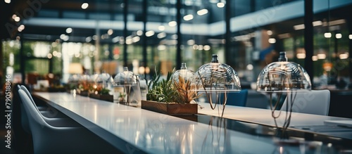 Interior of a modern restaurant with tables, chairs and decorative plants photo