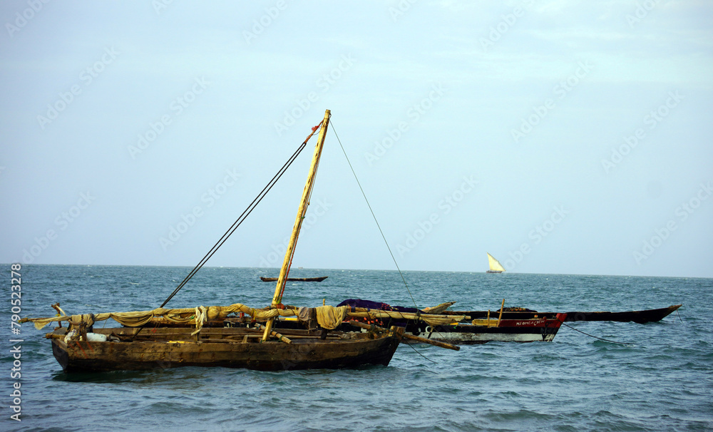Dhow moored near the shore on the northern Tanzanian coast with other boats in the background Dhow moored near the shore on the northern Tanzanian coast with other boats in the background