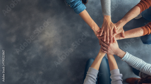 Diverse team joins hands for unity. Teamwork, collaboration, brainstorming. Minimalist studio photo.