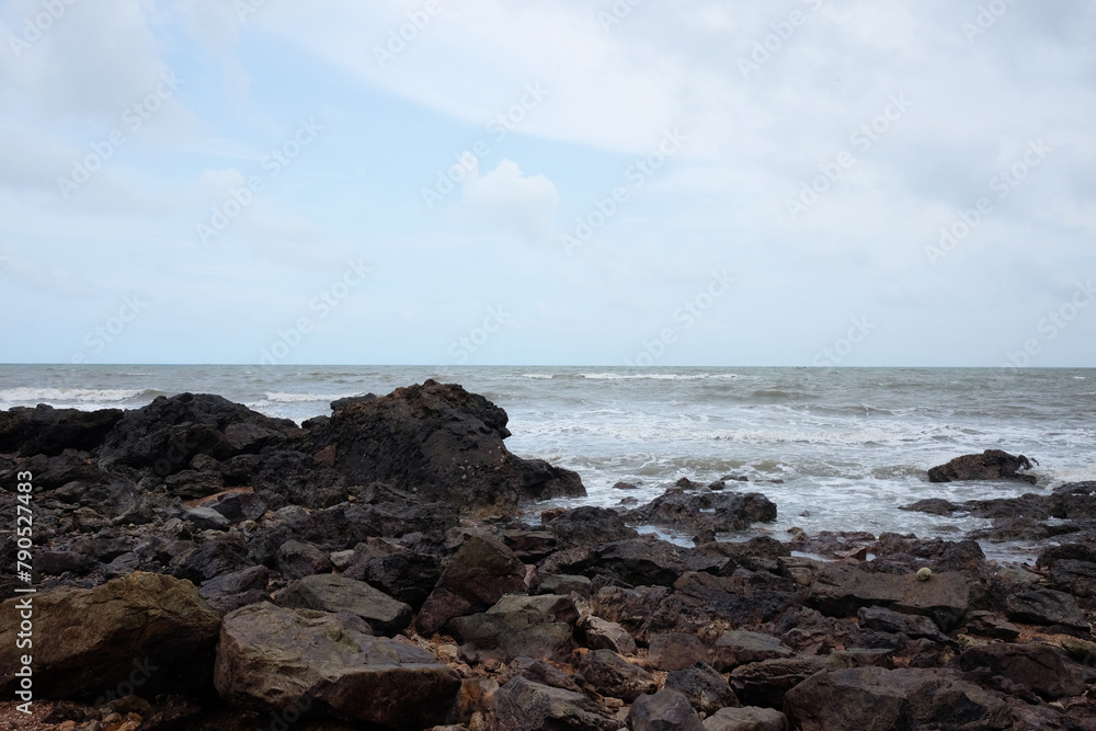 Beautiful landscape of Rocky coastline and blue sea with cloud storm on the sky in Thailand.Seascape concept