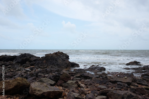Beautiful landscape of Rocky coastline and blue sea with cloud storm on the sky in Thailand.Seascape concept