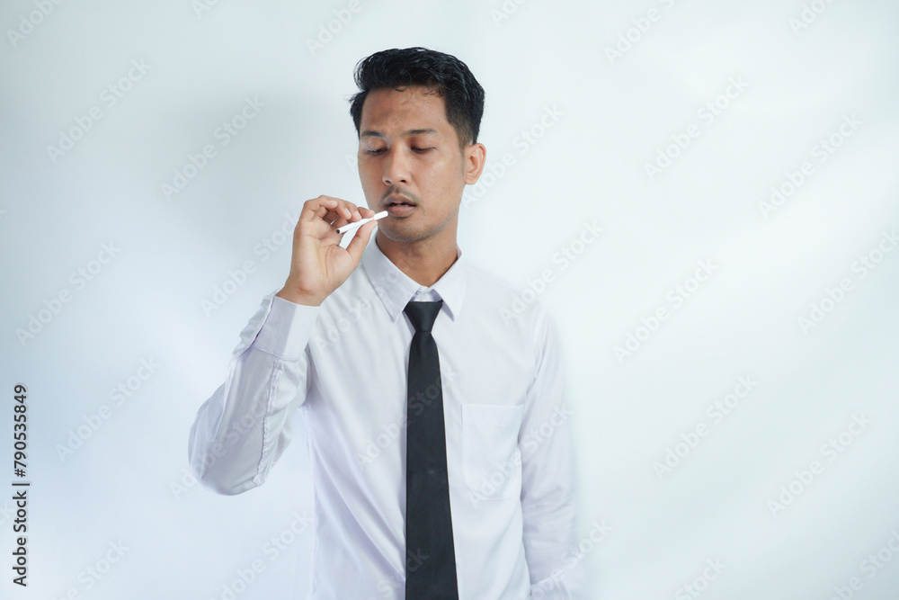 young handsome businessman smoking a cigarette young handsome businessman smoking a cigarette