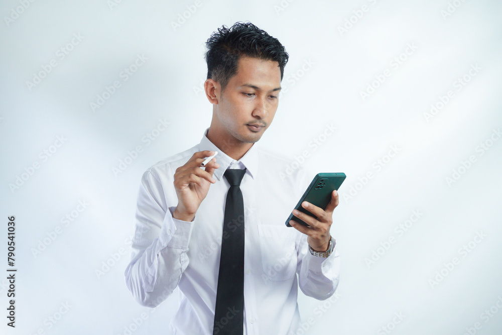 Man smoking cigarette and using smart phone Man smoking cigarette and using smart phone