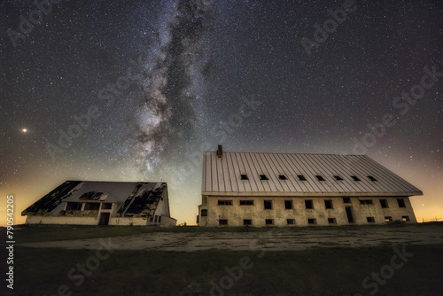 Milky Way over the abandoned buildings at the top of Picon Blanco, in Espinosa de los Monteros, Burgos, a cloudless night with a starry sky photo