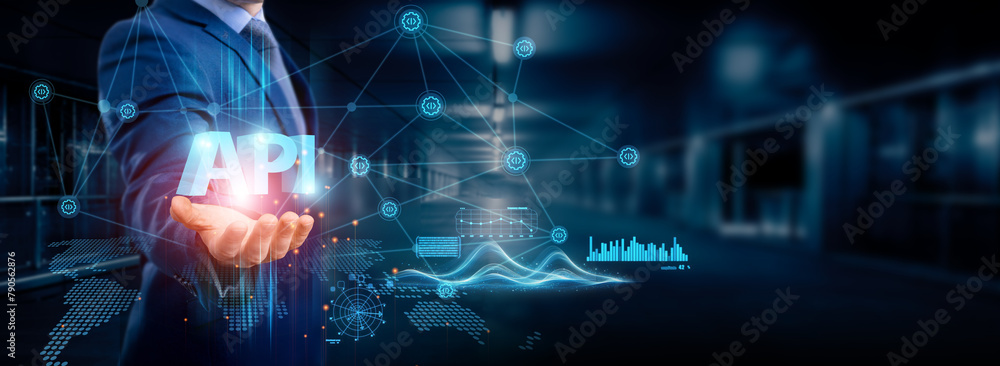 Businessman holding API icon global structure, networking and data integration for seamless connection, software development, cloud service, web application, IoT, and blockchain network. Businessman holding API icon global structure, networking and data integration for seamless connection, software development, cloud service, web application, IoT, and blockchain network.