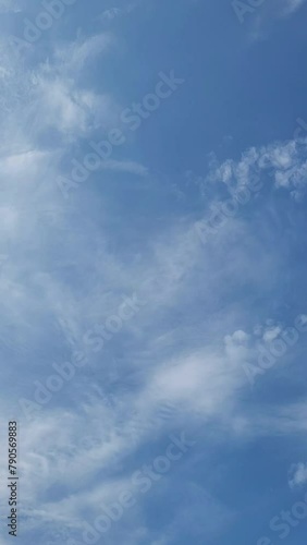 Blue Sky Background can used Template for Social Media Reels post. White Clouds on the Summer Sky. Beautiful vertical video with Skyscape.