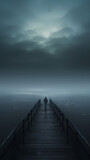A lonely figure stands at the end of the endless pier