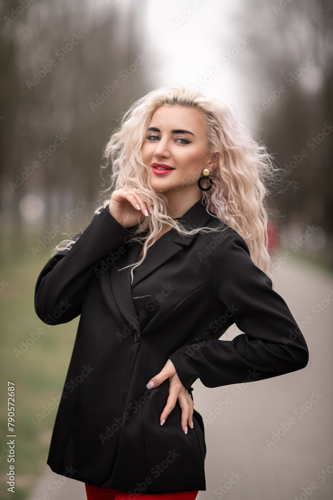 Portrait of a malty beautiful blonde girl on a city street. Portrait of a malty beautiful blonde girl on a city street.