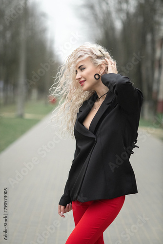 Portrait of a malty beautiful blonde girl on a city street.