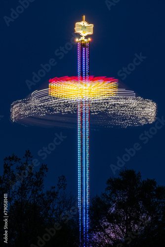 evening in an amusement park - a spinning tall illuminated carousel
