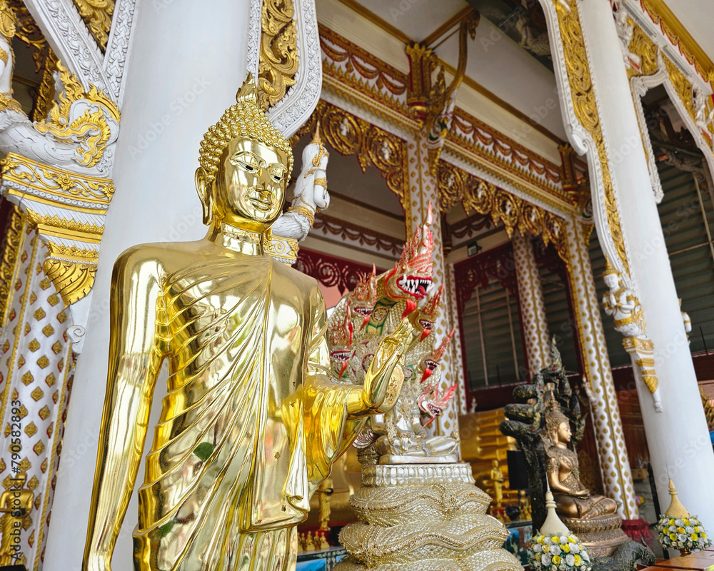 Fototapeta premium Golden Buddha statue at Rat Prakong Tham Temple, Nonthaburi Province