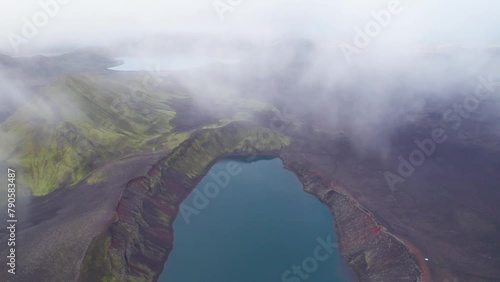 Epic Crater Lake Wide Drone Iceland Clouds Down Beautiful Landscape Ljotipollur Crater Blue Lake. Aerial Flight Icelandic Highlands Remote Travel Destination. photo