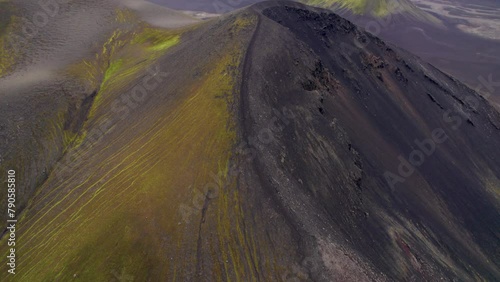 Epic Cinematic Aerial Over Ljotipollur Crater Black Volcano Remote Landscape Iceland. Black Sand, Green Grass Moss Rivers Mountains Low Clouds. High Quality 4K Color Corrected. photo