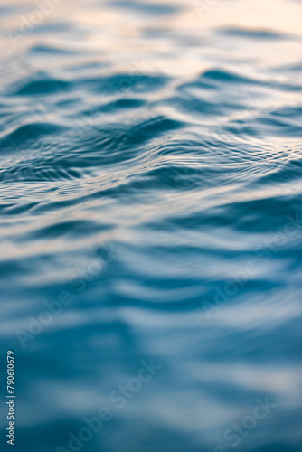 Beautiful sea waves ripples and sky reflection at sunset sunlight. Dream nature, beauty in nature ocean ecology concept. Artistic golden pastel blue fluid background. Closeup abstract natural light © icemanphotos