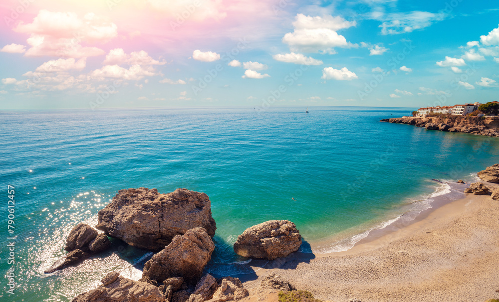 Seascape on a sunny day. Caletilla Beach with the beautiful sky. Promenade in summer. View from Mirador de Chanquete, Nerja, Malaga, Spain Seascape on a sunny day. Caletilla Beach with the beautiful sky. Promenade in summer. View from Mirador de Chanquete, Nerja, Malaga, Spain