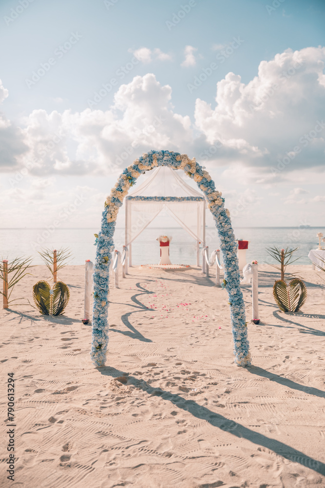 Bride and groom, newlyweds, honeymoon on dreamy beach sunset sun under wedding arch flowers. Love married young couple by the sea. Destination wedding ceremony on tropical island romantic sunlight Bride and groom, newlyweds, honeymoon on dreamy beach sunset sun under wedding arch flowers. Love married young couple by the sea. Destination wedding ceremony on tropical island romantic sunlight