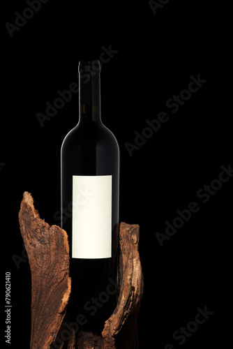 Bottle of red wine on a vintage rustic old wood