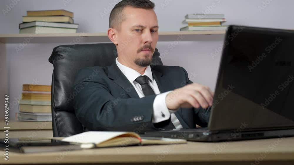 Young man finishing his work from home and closing laptop computer, relax stretching Young man finishing his work from home and closing laptop computer, relax stretching