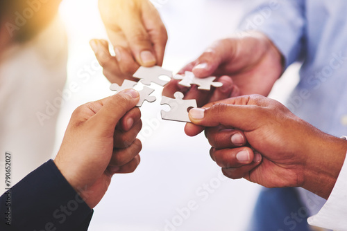 Diversity, business and hands of people with puzzle for unity or collaboration with joint effort for project. Group, teamwork and pieces together for planning or partnership, union and engagement.