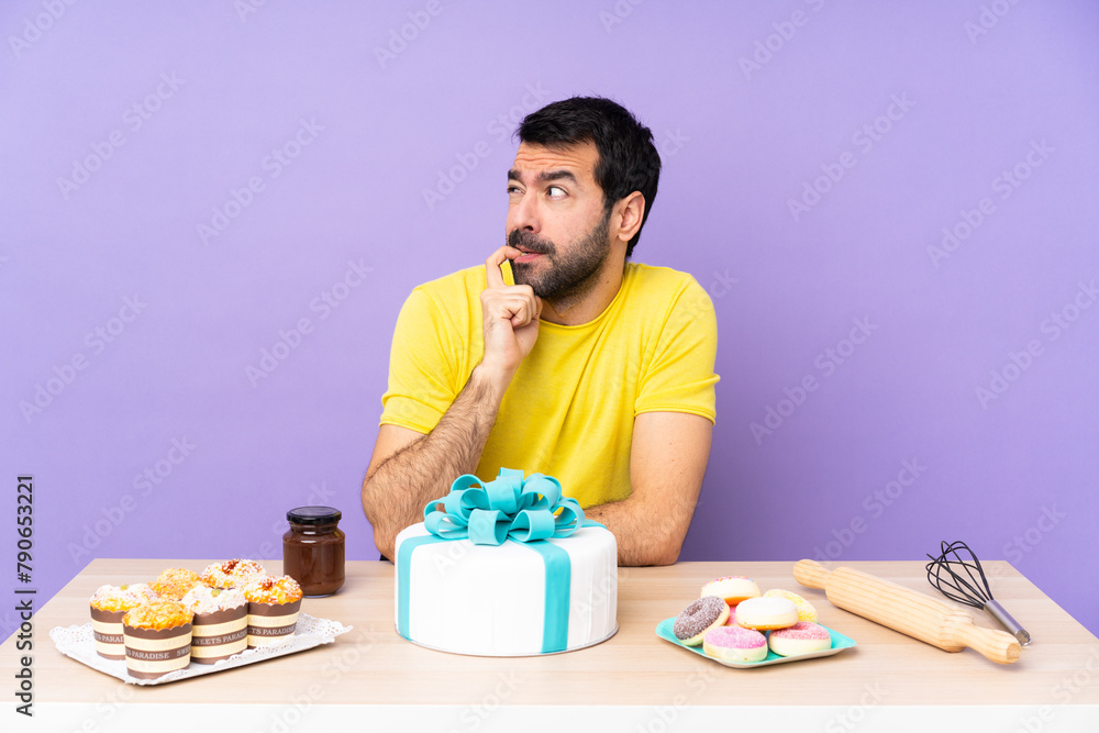 Man in a table with a big cake nervous and scared Man in a table with a big cake nervous and scared