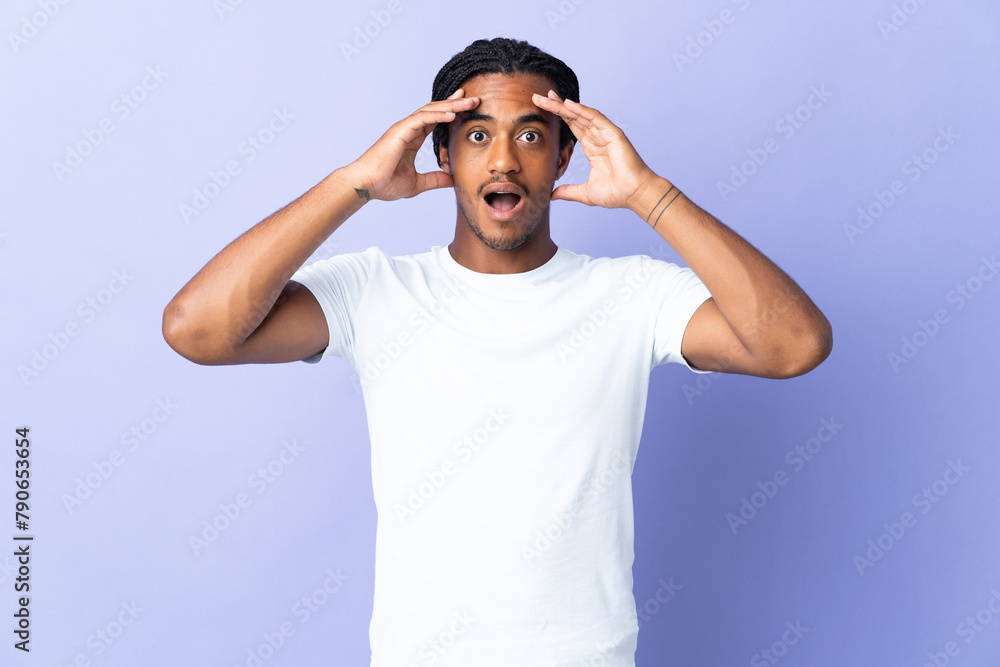 Young African American man with braids man isolated on purple background with surprise expression Young African American man with braids man isolated on purple background with surprise expression